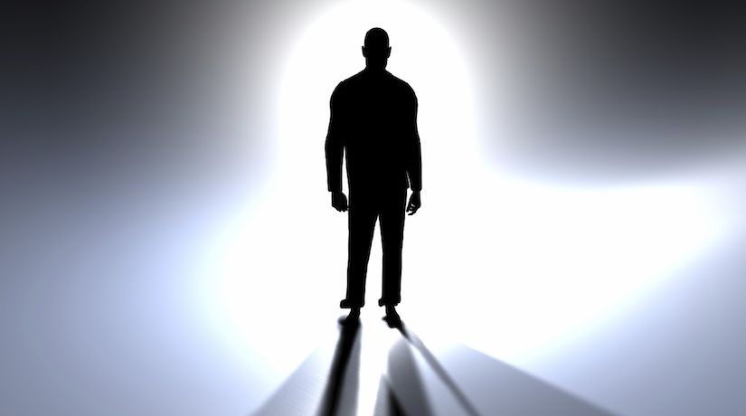 A silhouette of humanlike figure against a bright light to illustrate the article What Does the Bible Say About Angels?