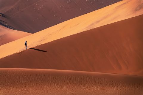 Graphic of a person on a distant sand dune to illustrate the article 