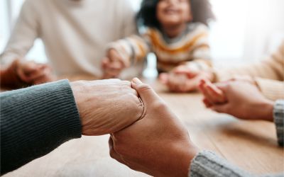 Photo of family holding hands to illustrate the article The Family That Prays Together