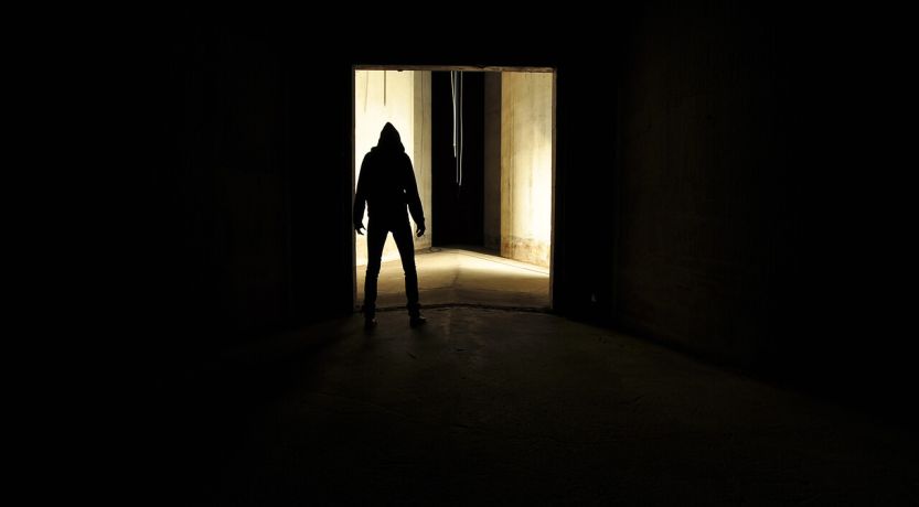 Photo of a shadowy figure in a distant doorway to illustrate the article Villains of the Bible