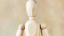 What Is Man? photo of wooden figure representing man